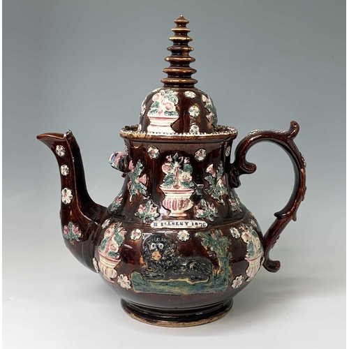 815 - A Measham treacle glazed barge ware teapot, dated 1876, of large proportions, the domed cover with '... 