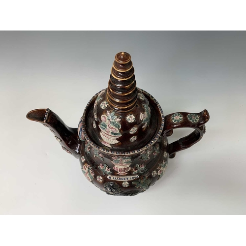 815 - A Measham treacle glazed barge ware teapot, dated 1876, of large proportions, the domed cover with '... 