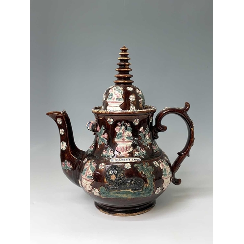 815 - A Measham treacle glazed barge ware teapot, dated 1876, of large proportions, the domed cover with '... 