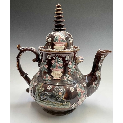 815 - A Measham treacle glazed barge ware teapot, dated 1876, of large proportions, the domed cover with '... 