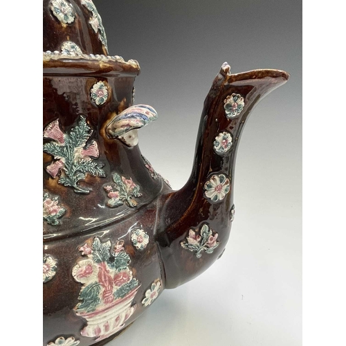 815 - A Measham treacle glazed barge ware teapot, dated 1876, of large proportions, the domed cover with '... 