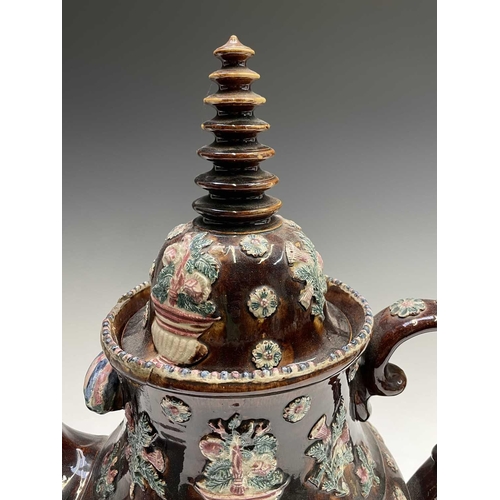 815 - A Measham treacle glazed barge ware teapot, dated 1876, of large proportions, the domed cover with '... 