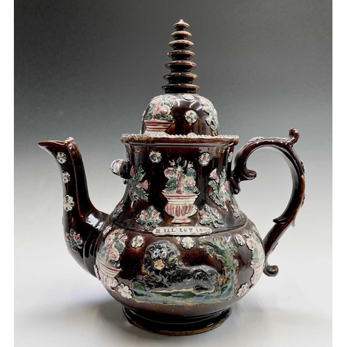 815 - A Measham treacle glazed barge ware teapot, dated 1876, of large proportions, the domed cover with '... 