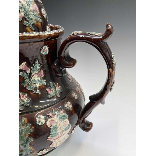 815 - A Measham treacle glazed barge ware teapot, dated 1876, of large proportions, the domed cover with '... 