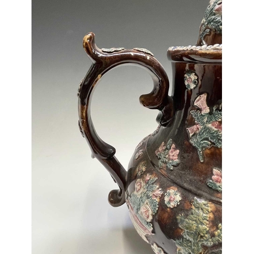 815 - A Measham treacle glazed barge ware teapot, dated 1876, of large proportions, the domed cover with '... 