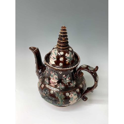 815 - A Measham treacle glazed barge ware teapot, dated 1876, of large proportions, the domed cover with '... 