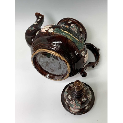 815 - A Measham treacle glazed barge ware teapot, dated 1876, of large proportions, the domed cover with '... 