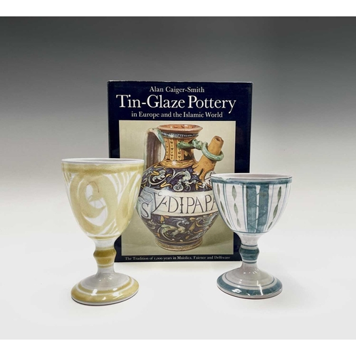 817 - Two Alan Caiger-Smith for Aldermaston Pottery goblets, the tallest 15cm, together with a book by the... 