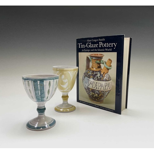 817 - Two Alan Caiger-Smith for Aldermaston Pottery goblets, the tallest 15cm, together with a book by the... 