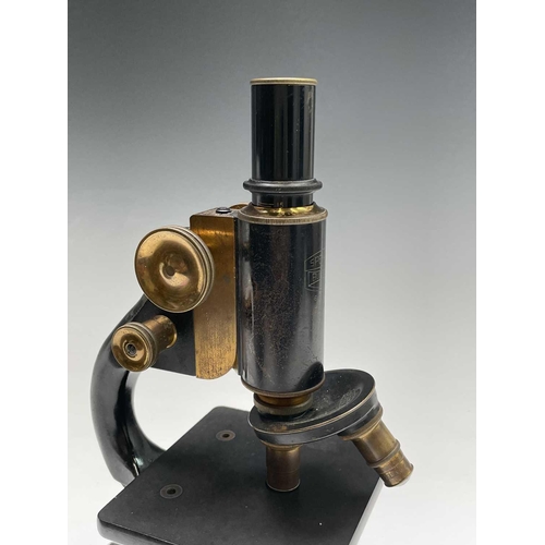 82 - A black lacquered and brass microscope, by Spencer, Buffalo, height 28cm, in stained pine case.