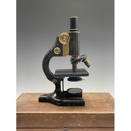 82 - A black lacquered and brass microscope, by Spencer, Buffalo, height 28cm, in stained pine case.