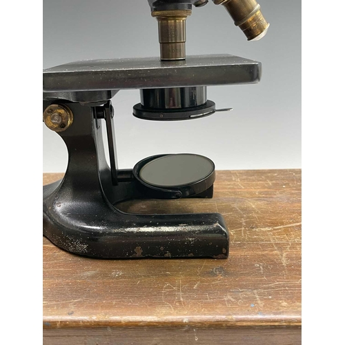 82 - A black lacquered and brass microscope, by Spencer, Buffalo, height 28cm, in stained pine case.