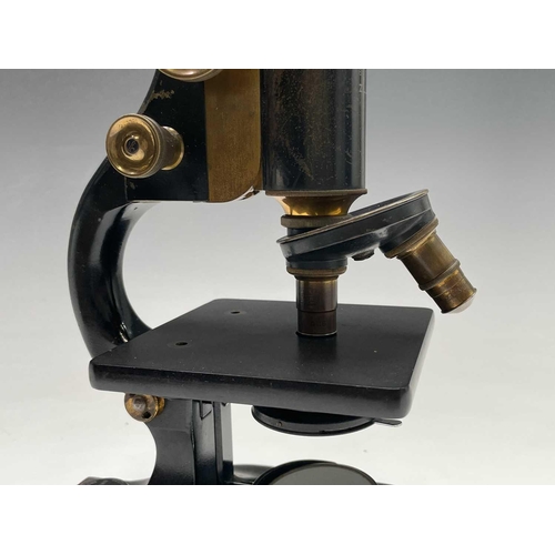 82 - A black lacquered and brass microscope, by Spencer, Buffalo, height 28cm, in stained pine case.