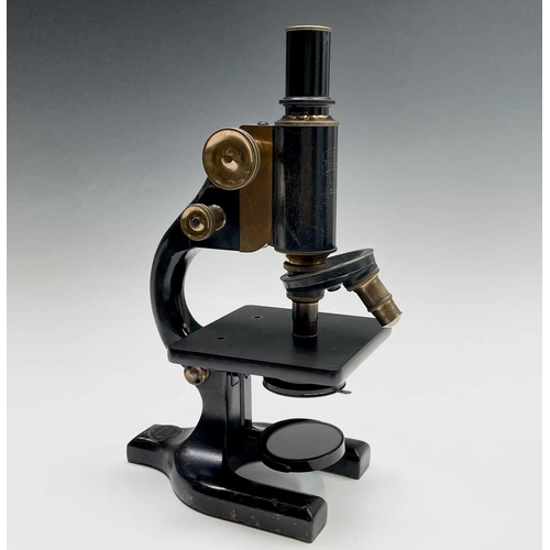 82 - A black lacquered and brass microscope, by Spencer, Buffalo, height 28cm, in stained pine case.