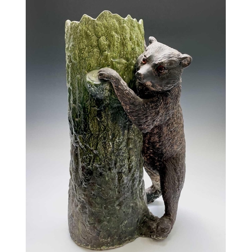 829 - A Bretby pottery stick stand, circa 1900, modelled as a brown bear with inset glass eyes standing be... 