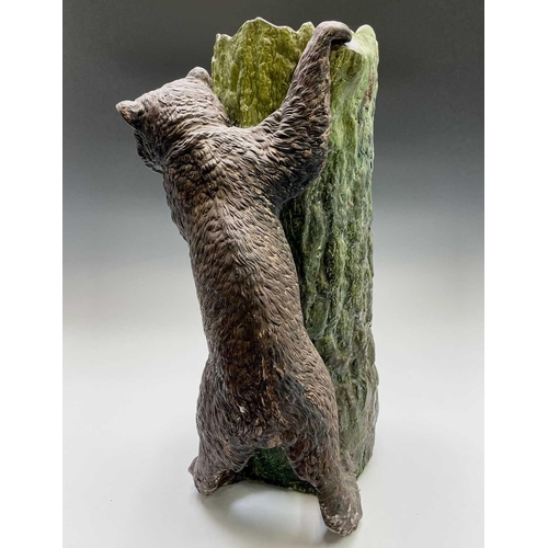 829 - A Bretby pottery stick stand, circa 1900, modelled as a brown bear with inset glass eyes standing be... 