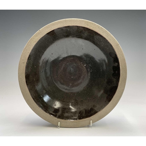 830 - A studio pottery plate with central unglazed band heightened in black, impressed seal mark, diameter... 