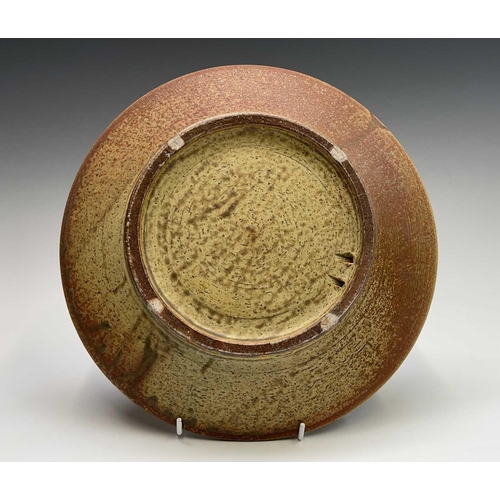 830 - A studio pottery plate with central unglazed band heightened in black, impressed seal mark, diameter... 