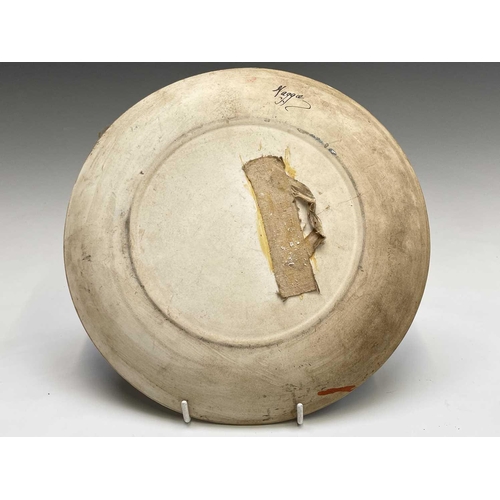 832 - A studio pottery unglazed plate, painted with a geometric floral design, the back indistinctly signe... 