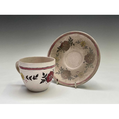 832 - A studio pottery unglazed plate, painted with a geometric floral design, the back indistinctly signe... 