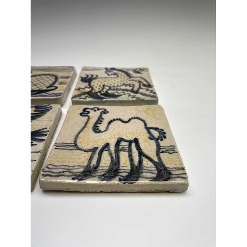 841 - A set of six studio pottery tiles, each hand painted with animal subjects, including a bird, a camel... 