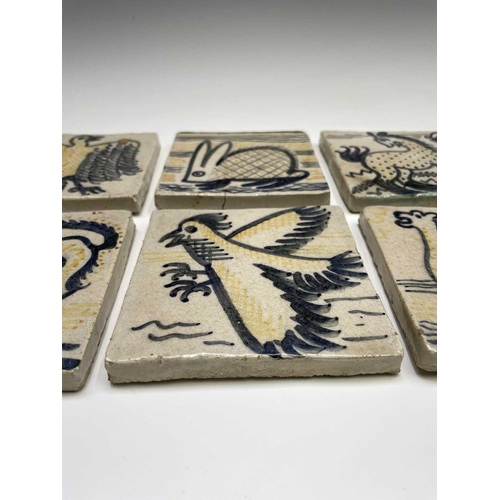 841 - A set of six studio pottery tiles, each hand painted with animal subjects, including a bird, a camel... 