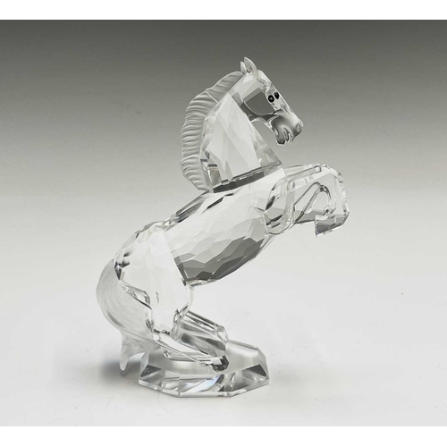 863 - Swarovski Crystal - a standing horse, height 13.5cm, a rearing horse, height 11cm, and a Swarovski C... 