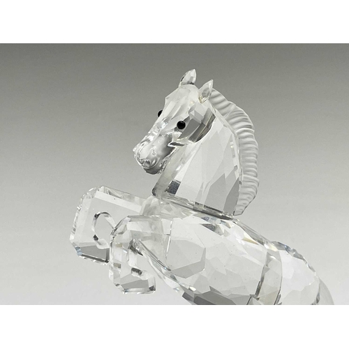 863 - Swarovski Crystal - a standing horse, height 13.5cm, a rearing horse, height 11cm, and a Swarovski C... 