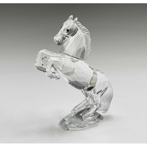 863 - Swarovski Crystal - a standing horse, height 13.5cm, a rearing horse, height 11cm, and a Swarovski C... 