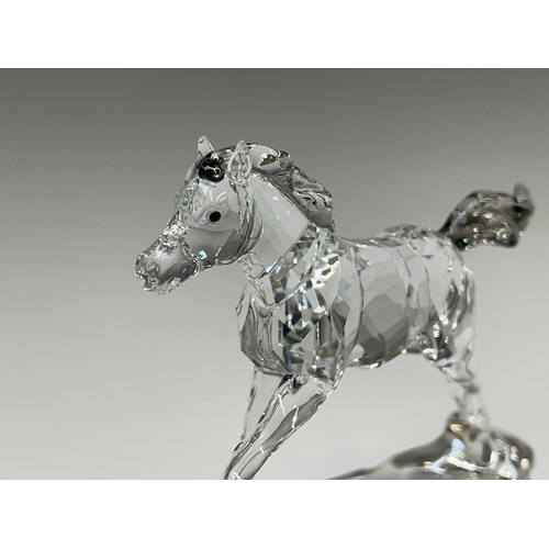 863 - Swarovski Crystal - a standing horse, height 13.5cm, a rearing horse, height 11cm, and a Swarovski C... 