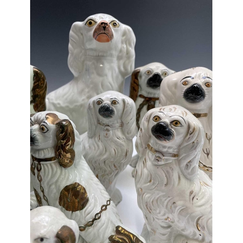 866 - A pair of Victorian pottery figures of spaniels, with green and gilt decoration and separate front l... 