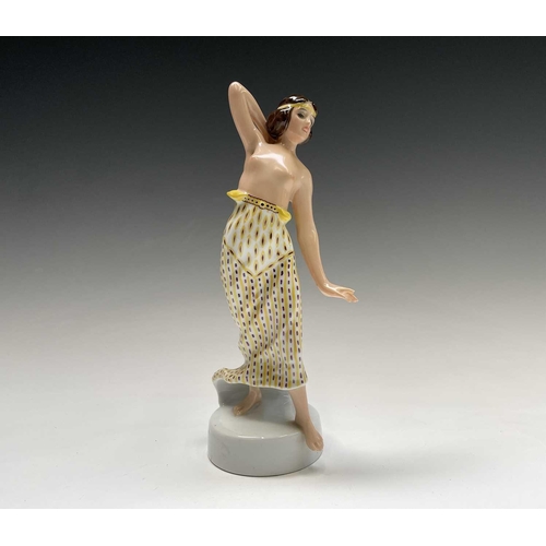 879 - A Rosenthal porcelain figure of a snake charmer, decorated in green and gilt, designed by Berthold B... 