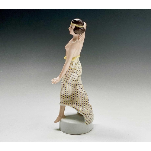 879 - A Rosenthal porcelain figure of a snake charmer, decorated in green and gilt, designed by Berthold B... 