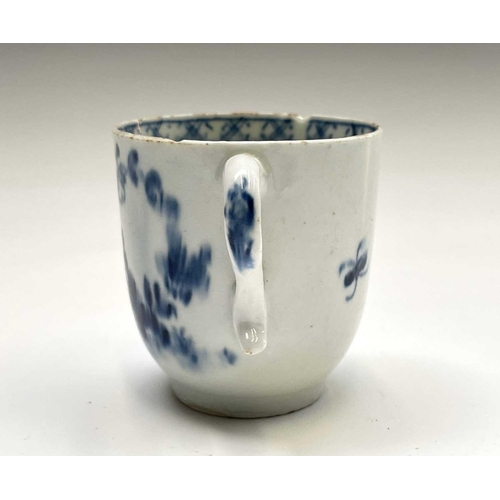 880 - A Lowestoft blue and white porcelain coffee cup, circa 1780, painted with a rock, flowering peony an... 