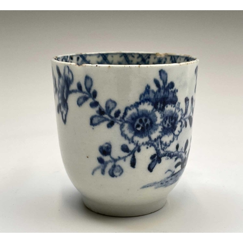 880 - A Lowestoft blue and white porcelain coffee cup, circa 1780, painted with a rock, flowering peony an... 