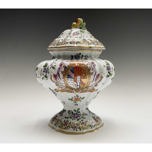 887 - An armorial tin glaze pottery jar and cover, circa 1900, with floral painted decoration, height 26cm... 