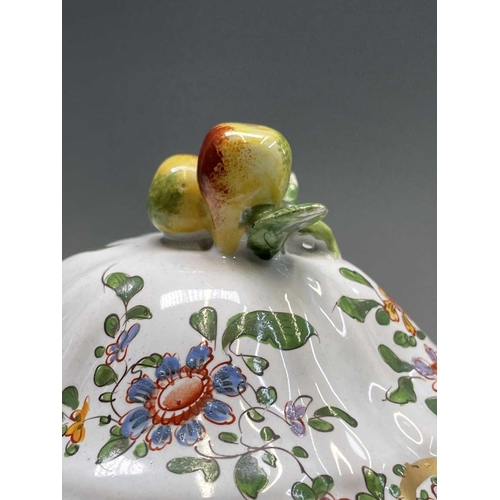 887 - An armorial tin glaze pottery jar and cover, circa 1900, with floral painted decoration, height 26cm... 