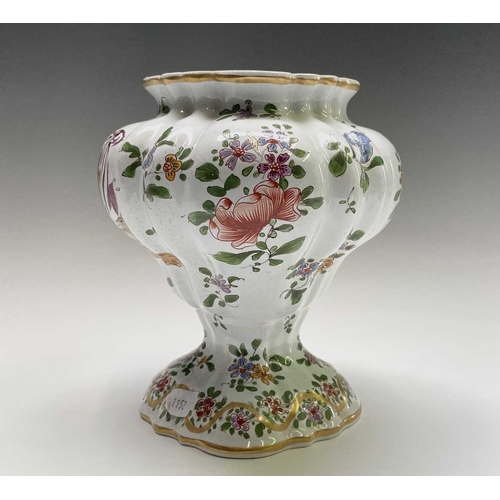 887 - An armorial tin glaze pottery jar and cover, circa 1900, with floral painted decoration, height 26cm... 