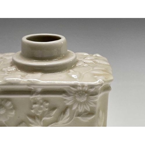 891 - A Continental white porcelain tea caddy, 19th century, moulded with flowers and foliage, height 11cm... 