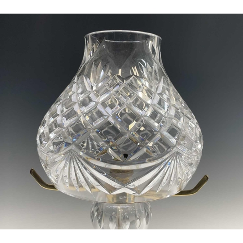 892 - A Waterford crystal cut glass table lamp and shade, supported on three brass arms and baluster stem,... 