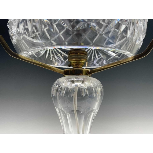 892 - A Waterford crystal cut glass table lamp and shade, supported on three brass arms and baluster stem,... 