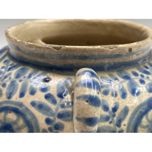 895 - A Continental tin glazed pottery strainer bowl, perhaps Spanish, 17th/18th century, with simple scro... 