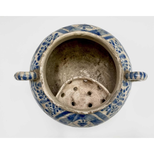 895 - A Continental tin glazed pottery strainer bowl, perhaps Spanish, 17th/18th century, with simple scro... 