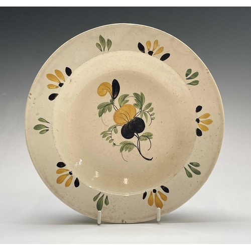 896 - A Greek earthenware plate, 19th century, painted in ochre, green and blue with a bird and flowers, t... 