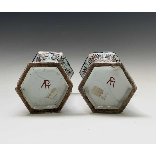 904 - A pair of Dutch Delft polychrome vases, 18th century, of hexagonal tapered form, painted in the Chin... 