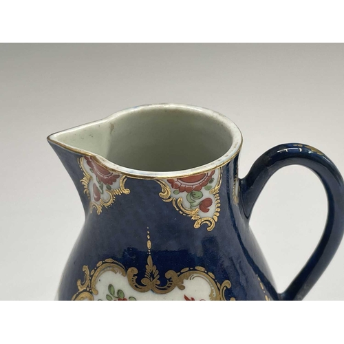 908 - A Worcester jug, circa 1770, the blue scale ground decorated with gilt edged floral panels, crescent... 