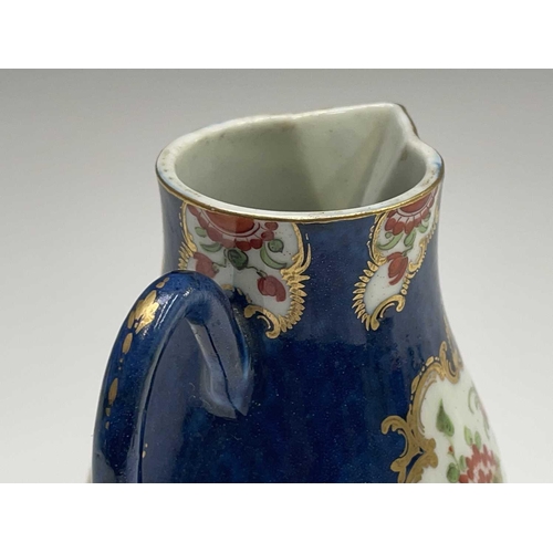 908 - A Worcester jug, circa 1770, the blue scale ground decorated with gilt edged floral panels, crescent... 