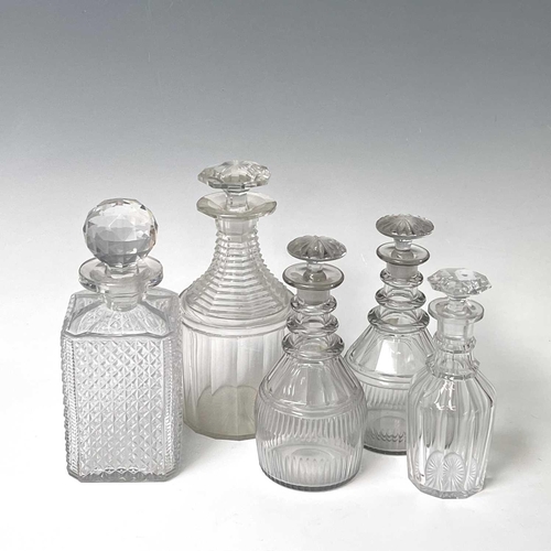 911 - A pair of Regency triple ring neck glass decanters and stoppers, with faceted and fluted decoration,... 