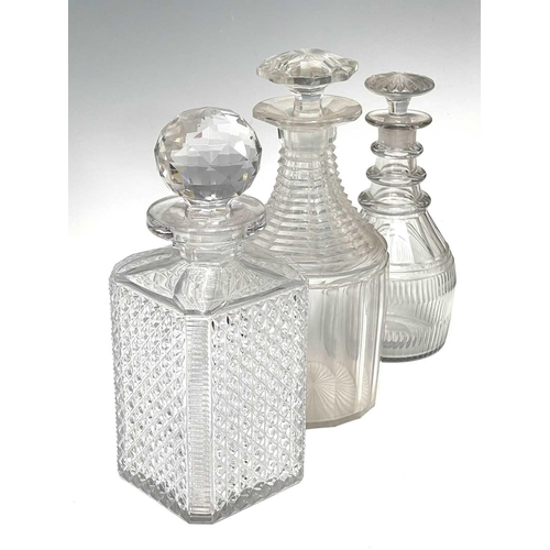 911 - A pair of Regency triple ring neck glass decanters and stoppers, with faceted and fluted decoration,... 