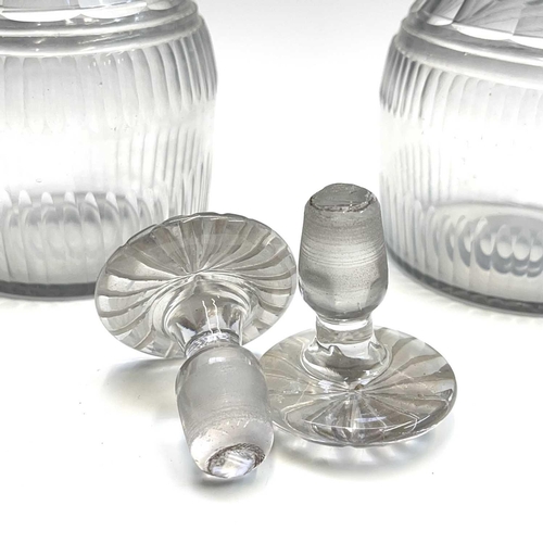 911 - A pair of Regency triple ring neck glass decanters and stoppers, with faceted and fluted decoration,... 